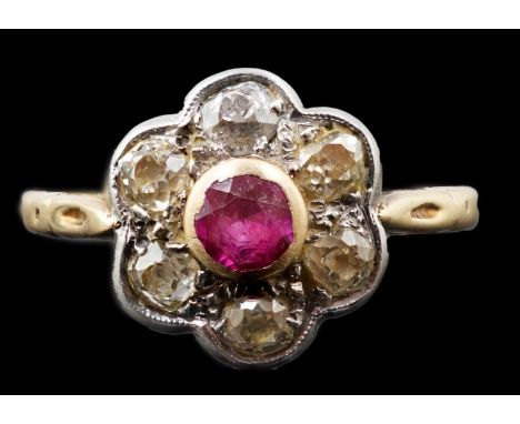 A gold and platinum, ruby and millegrain set diamond flower head cluster ring, size P, gross weight 2.7 grams.***CONDITION RE