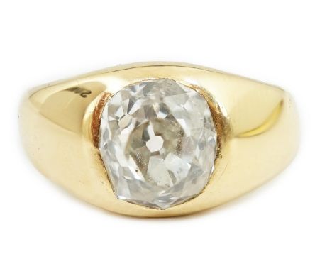 A George V 18ct gold and solitaire diamond gypsy set ring, the oval cushion cut stone measuring approximately 8.7mm by 8.2mm,