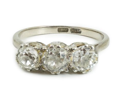 An 18ct white gold, platinum and three stone diamond set ring, the central stone diameter approximately 4.7mm, size Q/R, gros