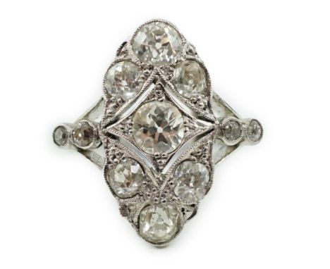 An early 20th century 18ct white gold, platinum and millegrain set old cut diamond cluster ring, of ovoid shape, with four st