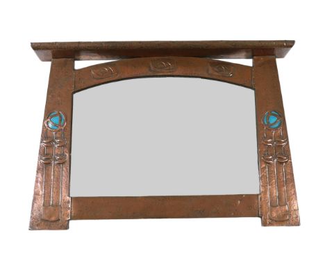 In the manner of Archibald Knox, a Scottish Arts &amp; Crafts planished copper overmantel, with shelf pediment over three Sco