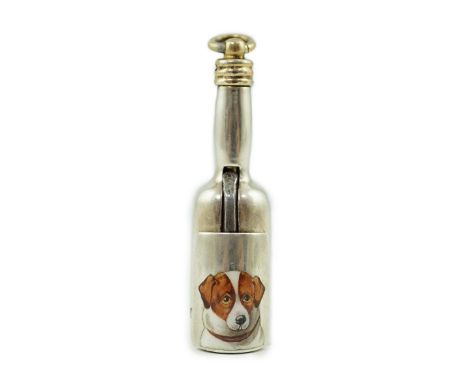 A late Victorian novelty parcel gilt silver cigar cutter, modelled as a bottle, the hinged section enamelled with a head of a
