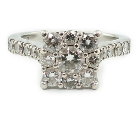 A modern platinum and nine stone diamond set square cluster ring, with ten stone diamond set shoulders, size M, gross weight 