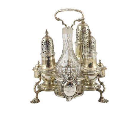A George II silver cruet stand, with three matching graduated casters, by Samuel Wood, with ring handle, on fluted pad feet, 