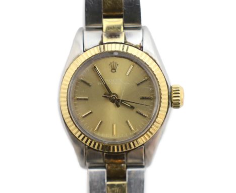 A lady's late 1970's/early 1980's stainless steel and gold Rolex Oyster Perpetual wrist watch, with yellow dial and baton num