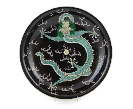 A Chinese enamelled porcelain 'dragon' dish, Kangxi mark but 19th century, boldly painted to the centre with a five claw drag