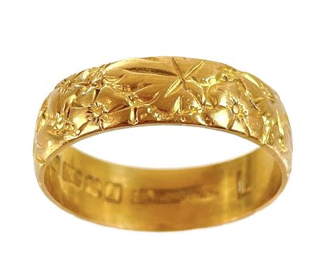 A 22ct hallmarked gold band ring with foliate engraved decoration. By Bravingtons, London 1964, size L 1/2, 4.28g.No sign of 