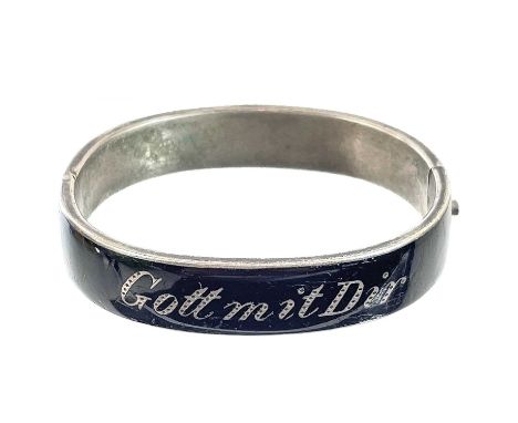 A 19th century silver and black enamel hinged mourning bangle. Inscribed 'Gott mitt Dir', 22g.
