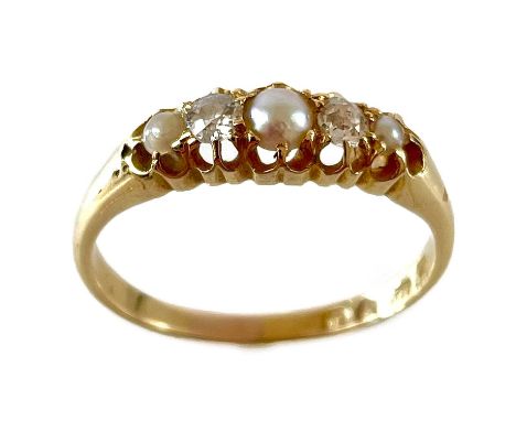 An Edwardian 18ct diamond and split pearl five stone ring. The two diamonds each measure 0.07ct, London 1907, size P 1/2, 2.9