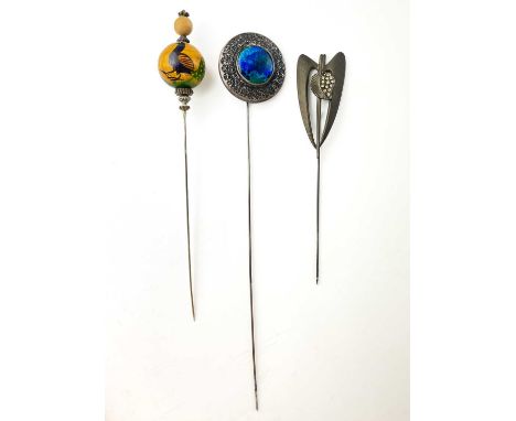An early 20th century silver and enamel hat pin by Charles Horner. Of disc form with embossed decoration and inset blue green