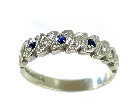 A 9ct white gold diamond and sapphire eight stone set half eternity ring. Set with small stones (one stone missing) size M, 3