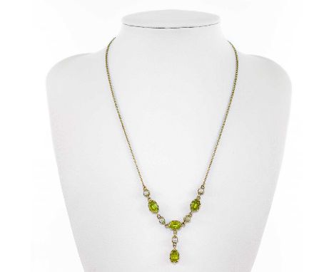 A 9ct peridot and seed pearl pendant necklace. Set with four oval cut peridot and five seed pearls, with a drop pendant, stam