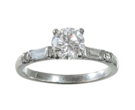 An 18ct white gold diamond solitaire ring. The round brilliant cut diamond in a four claw high setting and measuring 0.60ct a