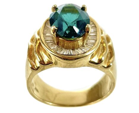 A stylish 18ct gold green tourmaline and diamond set dress ring. The oval cut tourmaline measuring 3ct approximately in raise