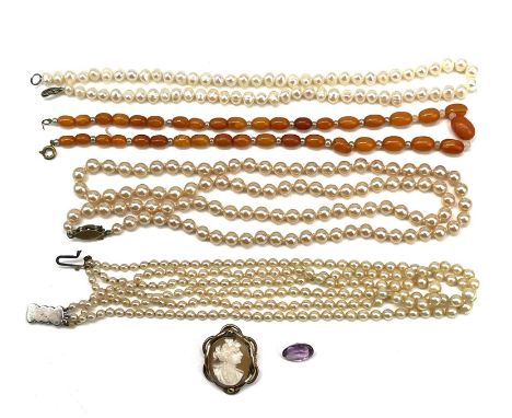 A yellow metal mounted shell cameo brooch, together with a loose oval cut amethyst, an amber and pearl bead necklace and thre