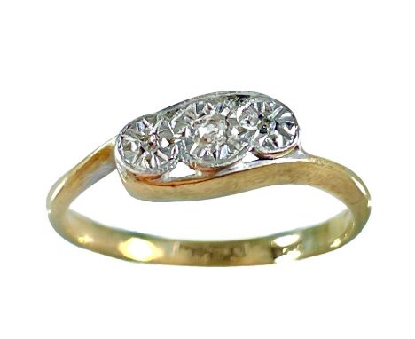 An early 20th century 18ct and platinum diamond set three stone ring. The three small diamonds in illusion setting, stamped 1