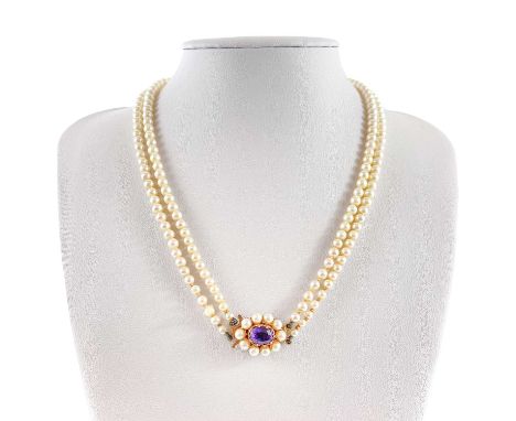 A 1960's cultured pearl graduated double row necklace with 9ct amethyst set clasp. Birmingham 1967, length 41cm.