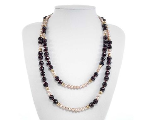 A modern 9ct garnet and pearl long necklace. The necklace with rows of garnet beads separated with rows of baroque pearls and