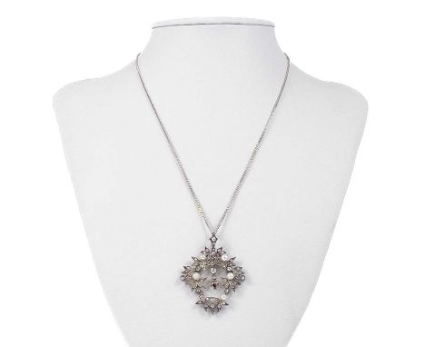 A delicate Edwardian rose gold (tests 9ct) diamond and pearl wreath pendant. Of leaf and berry design set with 49 small old c