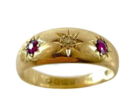 An 18ct gypsy set diamond and ruby three stone ring. Star set with a small diamond flanked by two rubies with estimated weigh