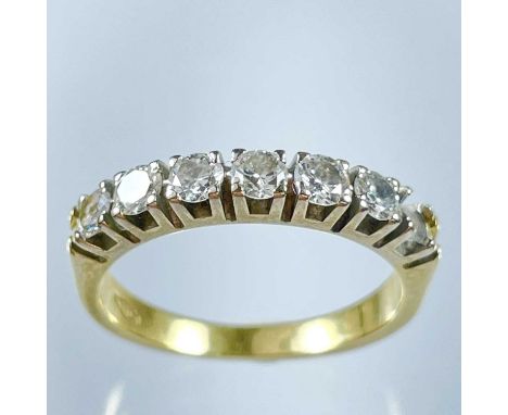 An 18ct diamond hoop set ring with six round cut stones, one missing. Each diamond measuring 0.07ct approximately, stamped 75