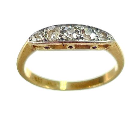 An 18ct and platinum diamond set five stone ring. Set with small round cut diamonds, the largest 0.05ct, size J, 2.4g.