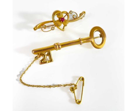A 1940's 15ct bar brooch and a 9ct key design '21' bar brooch. The 15ct brooch garnet and pearl set, Chester 1947, 2.24g, the