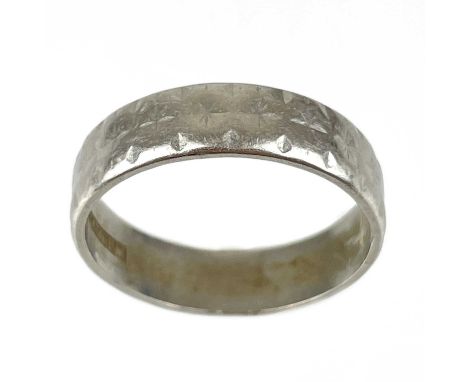 A platinum band ring with engraved decoration. Stamped PLATINUM, size O, 5.82g.