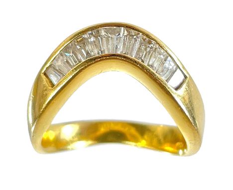 A high purity gold diamond set eleven stone wishbone ring. The tapered baguette diamonds channel set, stamped 850 but tests a
