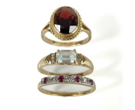 Three 9ct gold stone set rings. To include a diamond and ruby seven stone ring, each diamond 0.03ct, size O; an aquamarine ri