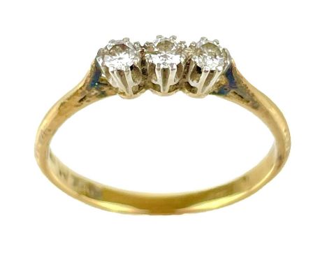 An 18ct and platinum diamond three stone ring. Each stone measuring 0.04ct, size M, 1.9g.