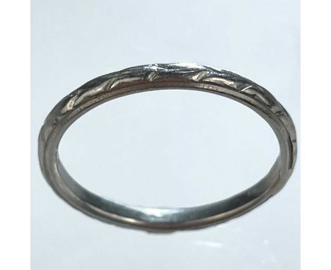 A platinum band ring. With engraved decoration, stamped PLAT, size M, 2.74g.