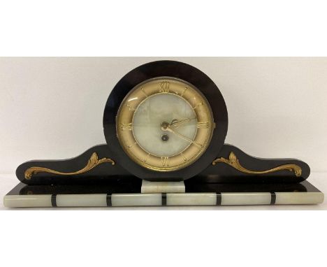 An Art Deco black slate and onyx mantle clock with gold scroll applique detail. Onyx face with gold tone hour markers and han