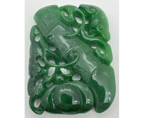 A carved piece of jade in the form of a bamboo stem and a gourd with mixed foliage. Carved detail to both sides. Approx. 7cm 