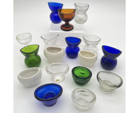 A collection of 17 assorted clear and coloured glass and ceramic eye wash cups. In varying styles, to include amber, green an