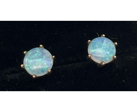 A pair of 9ct gold and opal stud earrings for pierced ears. Single round cut opal stone in a claw mount, each stone approx. 6