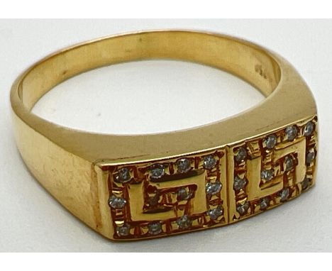 A modern 18ct gold ring with Greek key design mount set with 24 small diamonds. Stamped 750 inside band. Ring size U. In orig