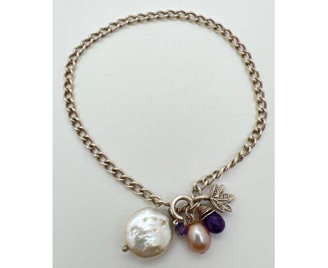 A 925 silver 7.5 inch curb chain bracelet with pearls, amethyst and leaf charms and spring ring clasp. Silver marks to clasp.