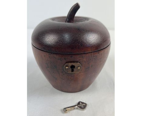A Georgian style wooden tea caddy in the shape of an apple, with hinged lid. Complete with key, interior lined with metallic 