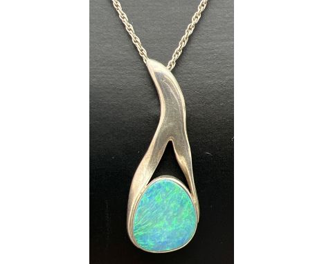 A vintage contemporary design silver pendant necklace set with an opal, on a 20" rope chain. Pendant marked J.E.D. Hallmarked