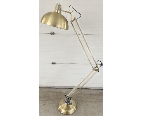 A new and unused brushed gold metal floor standing anglepoise standard lamp. Complete with original boxes, instruction sheet,