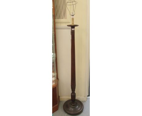 An early 20thC mahogany standard lamp, fashioned as a reeded column, on a splayed disc design base&nbsp; 60"h&nbsp; 
