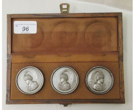 A set of three Asian silvered steel tablets, each featuring the profile head and shoulders portrait of an uniformed man, wear