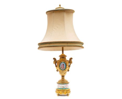 A late 19th century French 'Sevres' porcelain and ormolu table lamp: vase shaped body inset with porcelain panels of cupid an