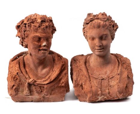 Two terracotta busts of a young woman and man: the man wearing a lion skin cloak, the lady with a garland of flowers in her h
