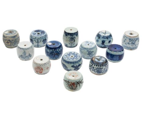 A collection of thirteen Chinese porcelain scroll weights: of barrel form, painted in blue and iron-red with auspicious symbo