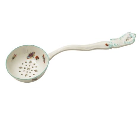 A Chelsea-Derby sugar sifter spoon: with pierced bowl, the 'hour glass' handle with moulded scrolls picked out in greenish tu