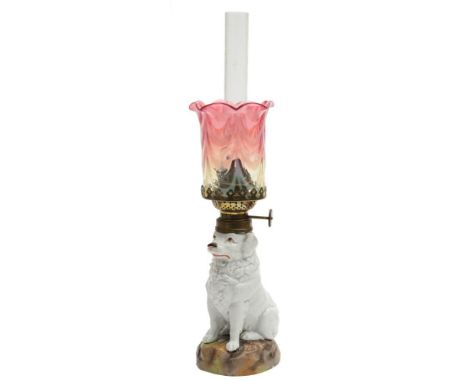 A Continental porcelain oil lamp in the form of a dog: seated on mound base, impressed LBS with numerals, late 19th century, 