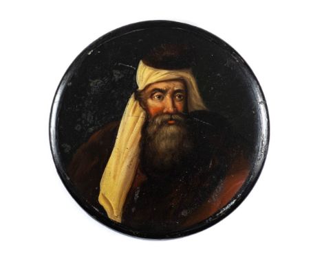 A 19th century papier mache snuff box: the circular lid decorated with a portrait of a bearded figure wearing a red cape and 