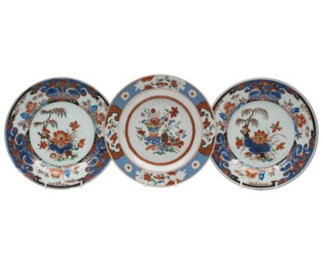 A pair of Chinese verte Imari plates and one other: the pair painted with lotus, peony and other flowers and foliage within b